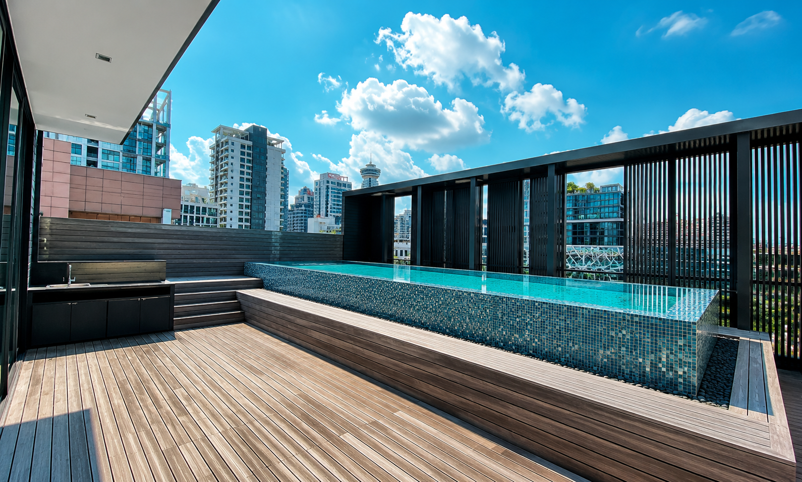 Rooftop penthouse pool deck with the Singapore skyline
